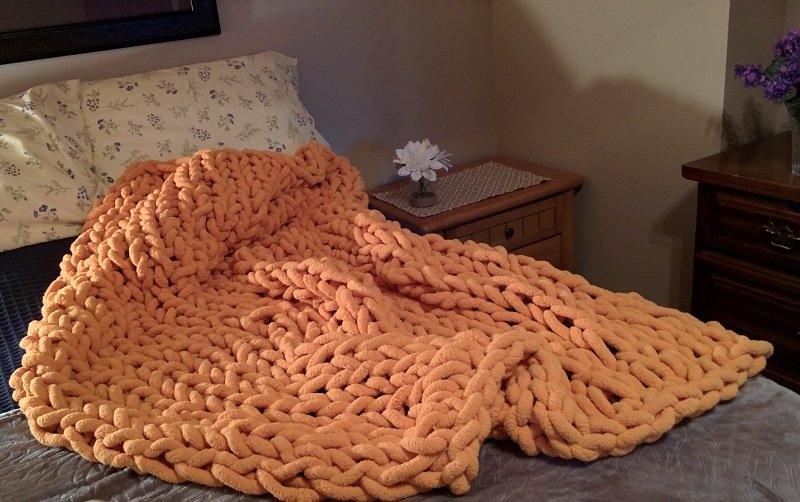 cozy chunky chenille yarn on bed