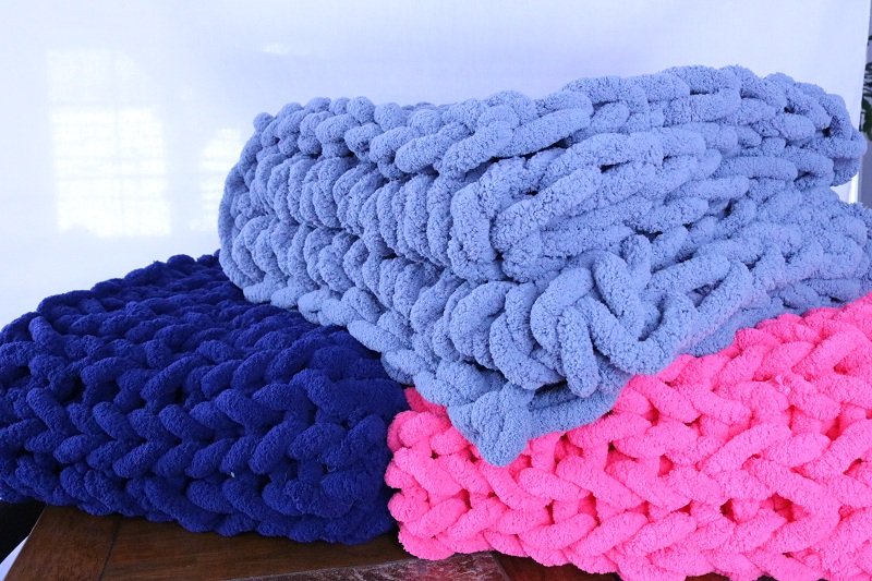 stack of colourful chenille blankets
